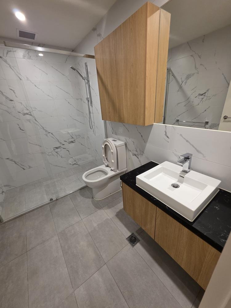 Marble-look bathroom, vanity and shower after cleaning