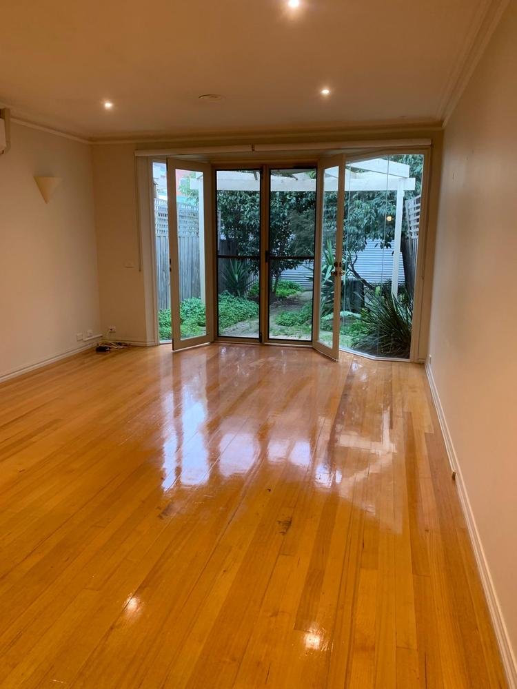 Polished timber floor leading to garden doors after cleaning
