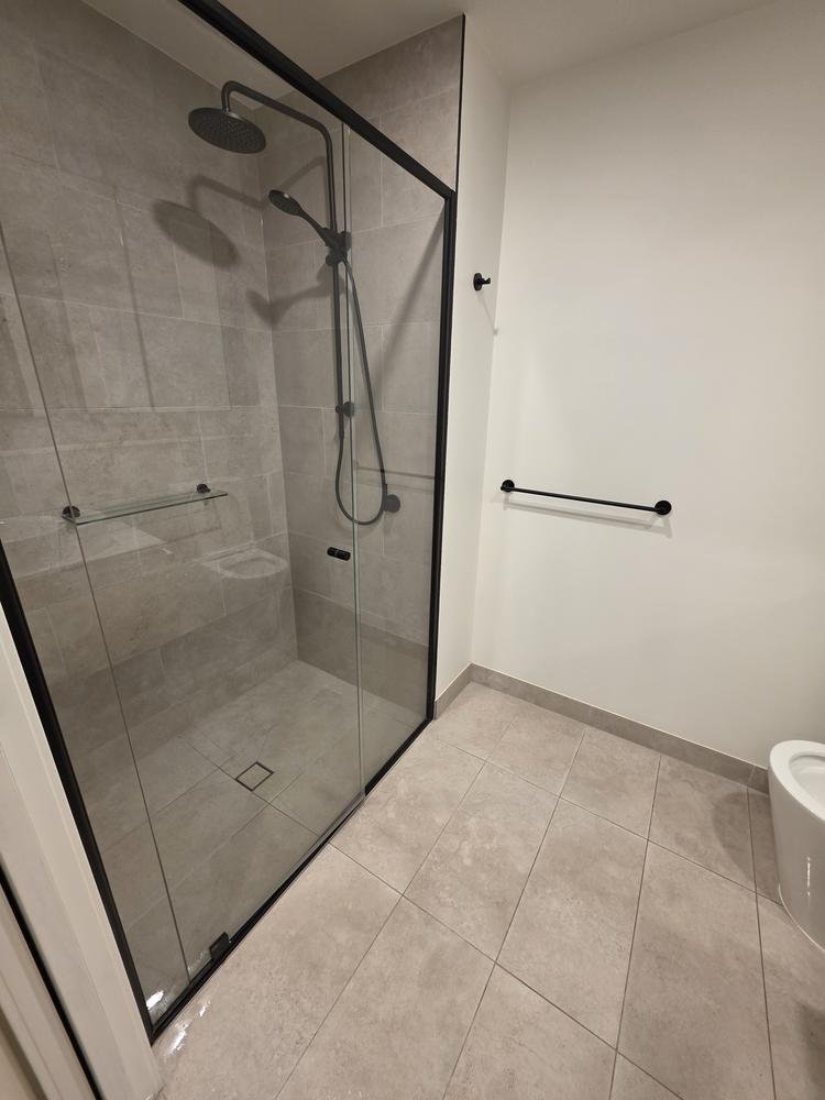 Grey tiled shower and bathroom floor after cleaning
